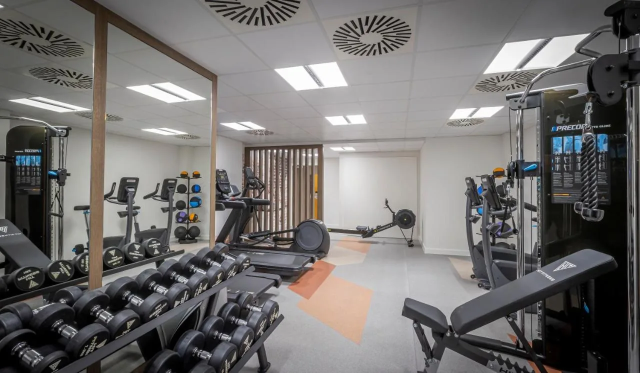 a gym with lots of treadmills and machines at Clayton Hotel Glasgow City in Glasgow